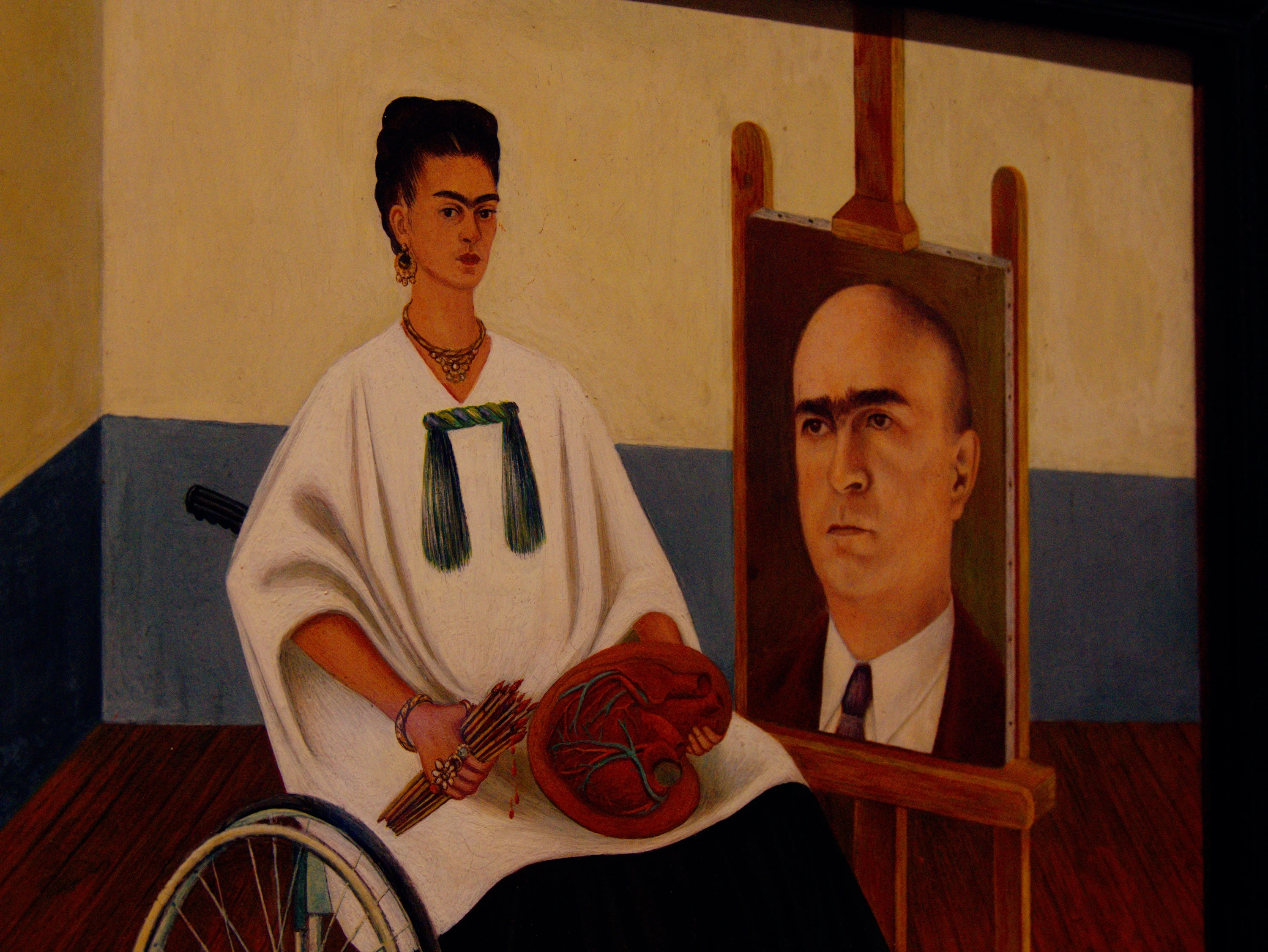 Self-Portrait with the Portrait of Doctor Farill — Frida in a wheelchair holding a heart-shaped palette