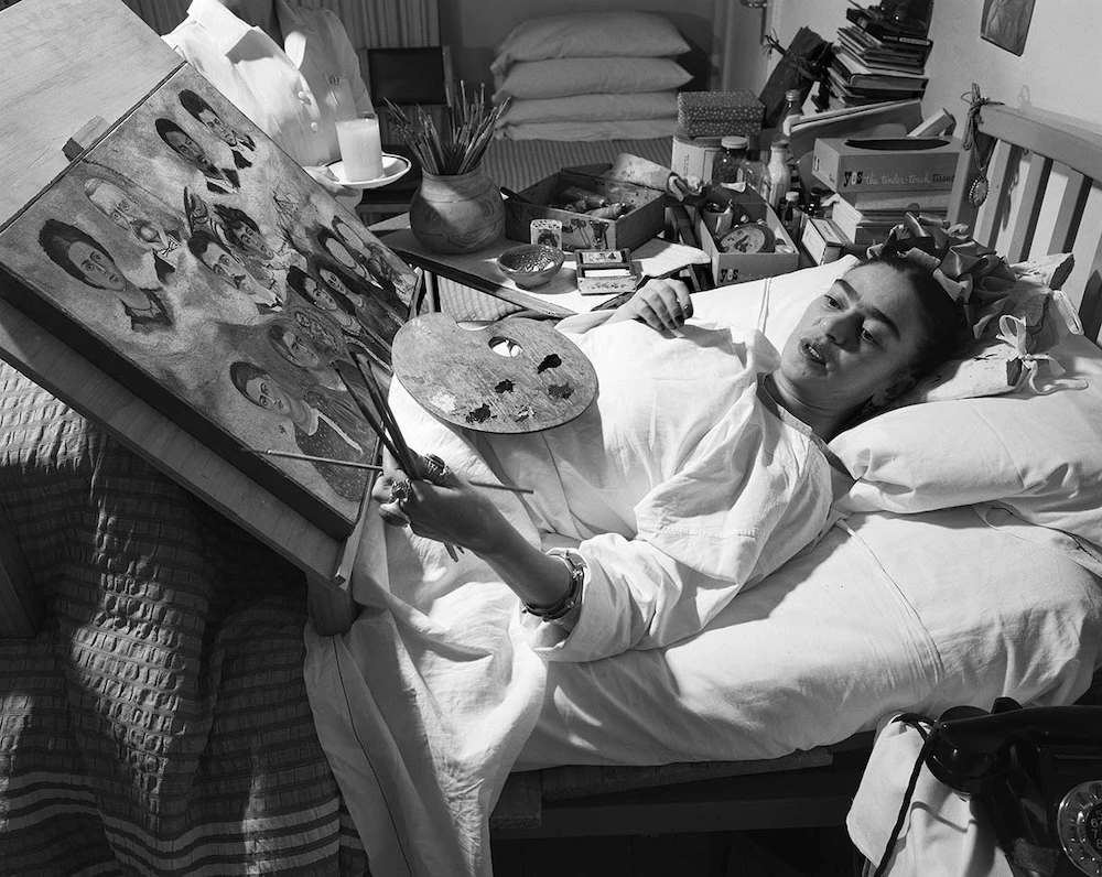 Frida painting in her bed